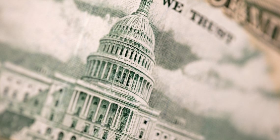 Dollar bill being used in government grant funding