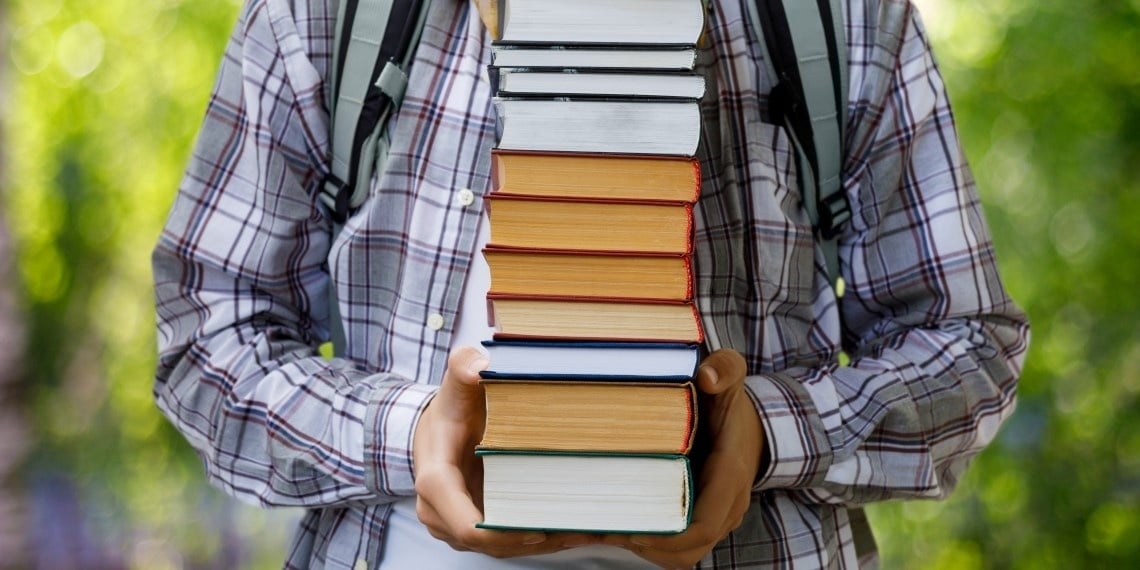 Successful nonprofit major gifts fundraising visual of a student holding a stack of books