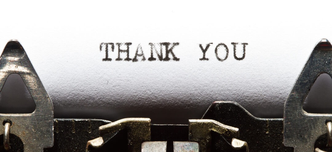 A typewriter showing a thank you note to a nonprofit donor