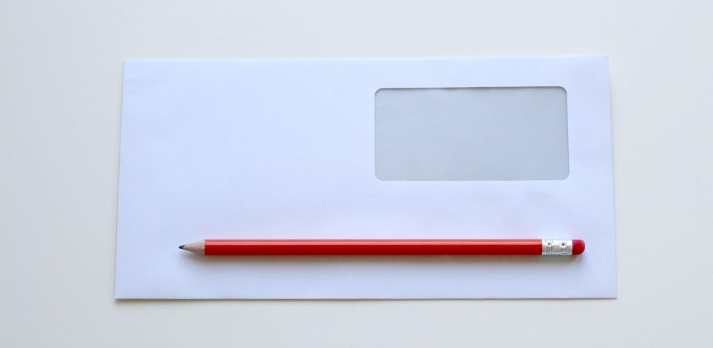 Direct mail for nonprofit fundraising visual of pencil and a white envelope
