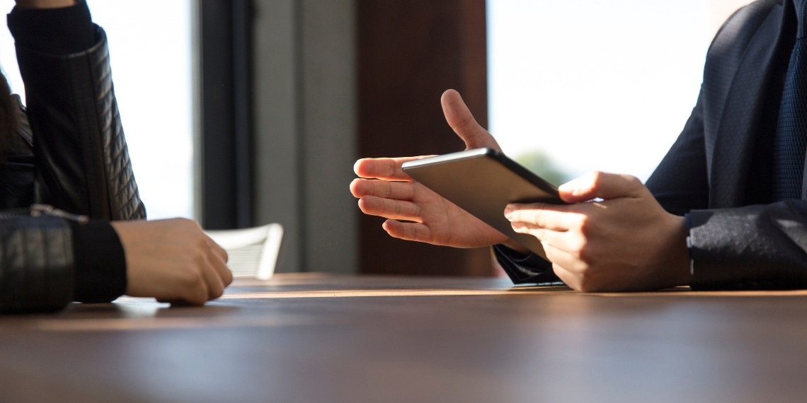 Nonprofit leader and fundraising consultant discussing at a table.