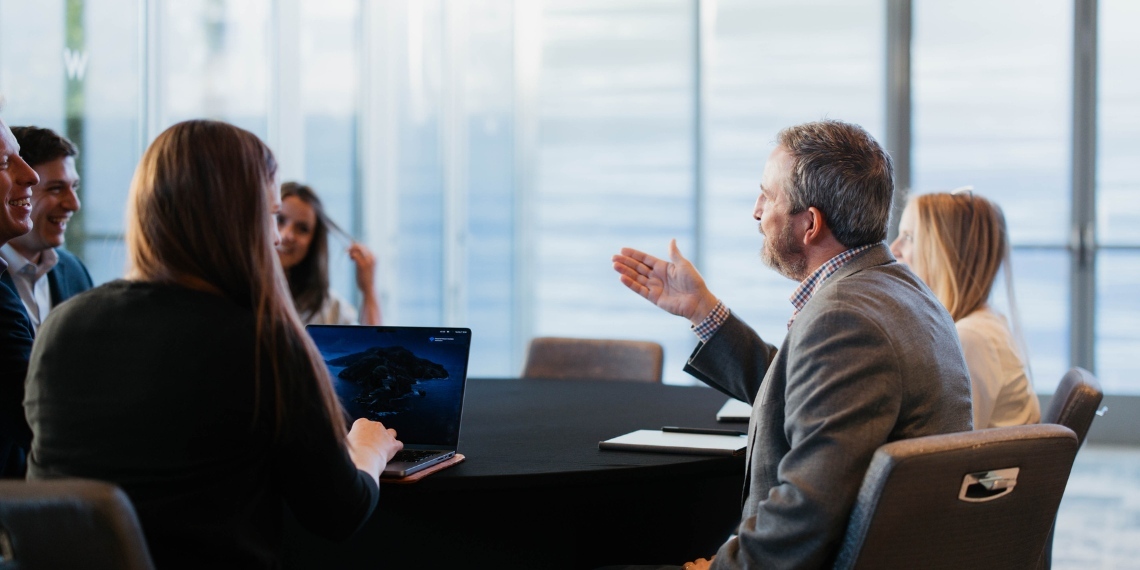 Nonprofit leader and staff sitting at a table discussing their organization's strategy