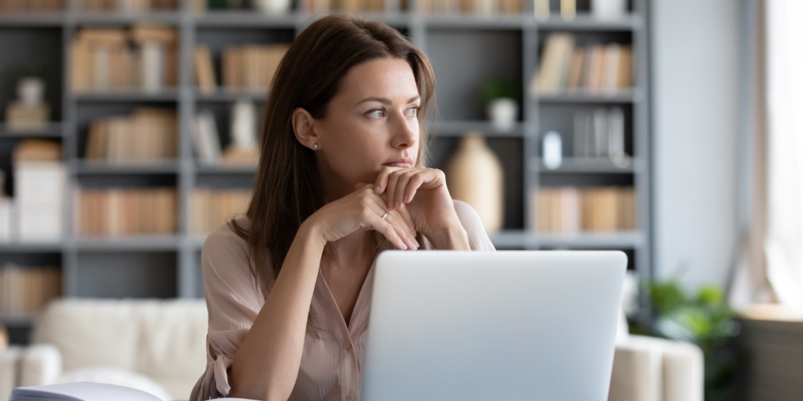 Direct Mail Response Fundraising woman thinking of her next compelling message at a desk