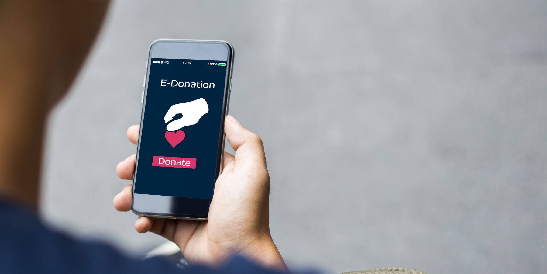 Best fundraising CRM software example of a person holding a phone with donation confirmation