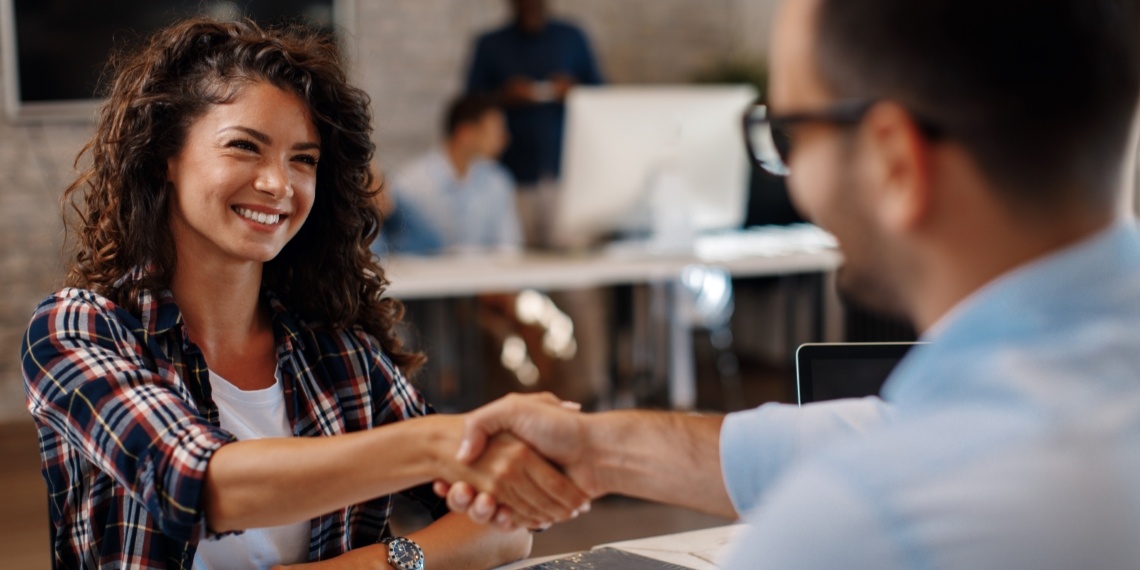 Nonprofit hiring process visual of woman shaking hands with a man after an interview