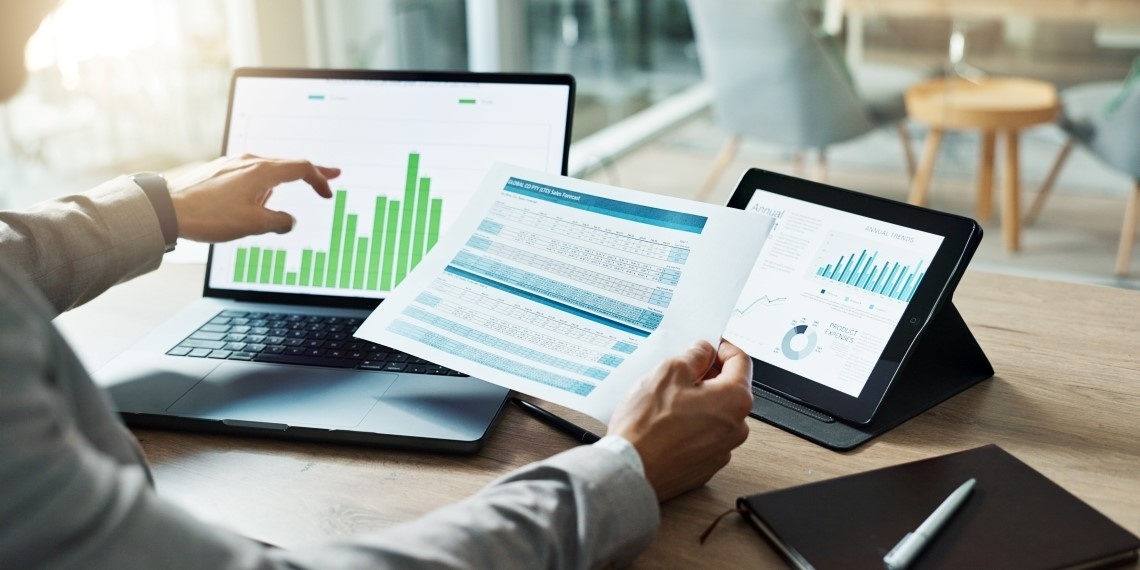 Best fundraising software for nonprofits visual of charts on laptop with someone working with them