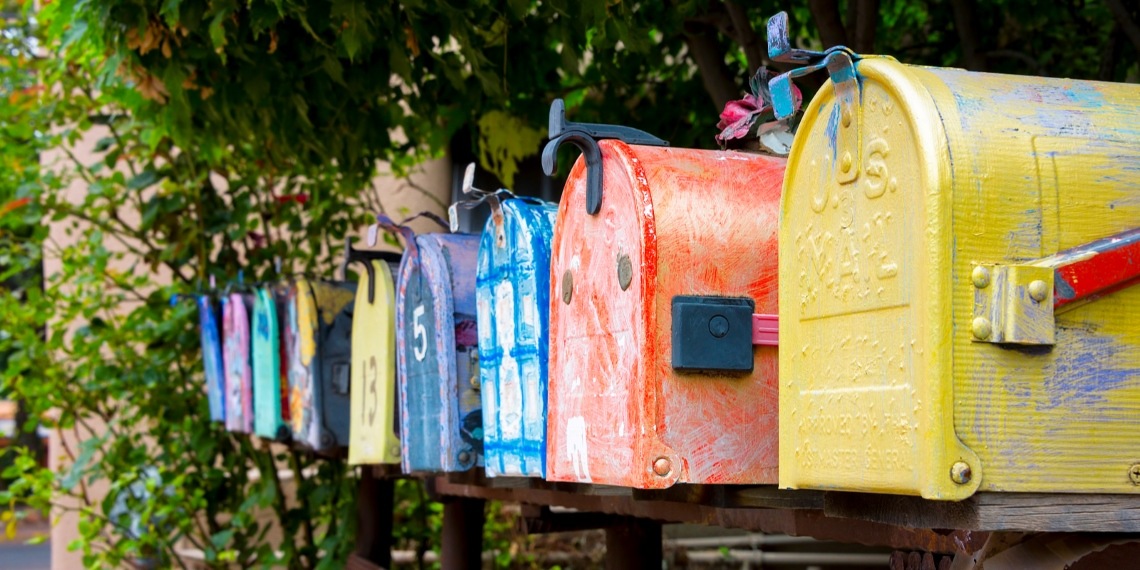How to avoid shady direct mail firms illustrated by a line of mailboxes 