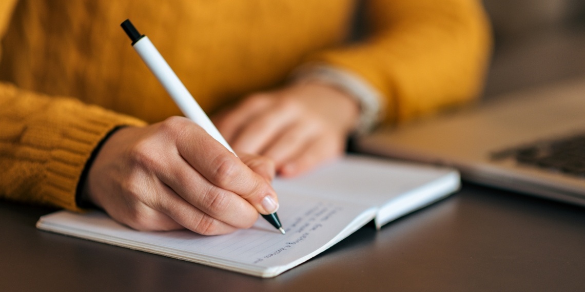 Direct mail fundraising person writing on a piece of paper