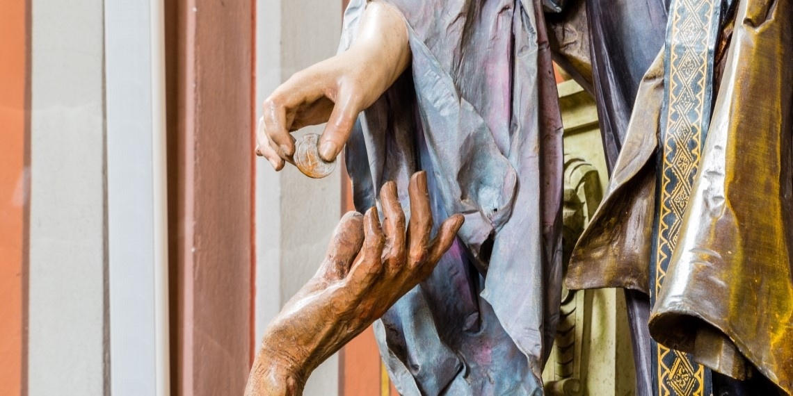 Nonprofit news on giving illustrated by statue hand charitably giving a coin to another statue hand