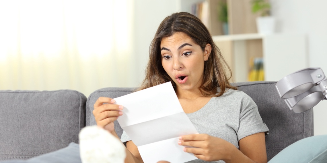 Nonprofit direct mail drama visual of a woman reading a letter and looking surprised