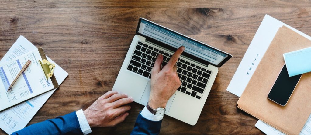 Nonprofit Donor Database with man pointing at records on a laptop screen