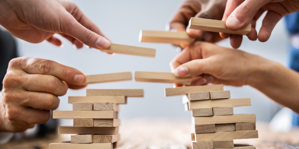 Philanthropists building block towers and working together to protect philanthropy